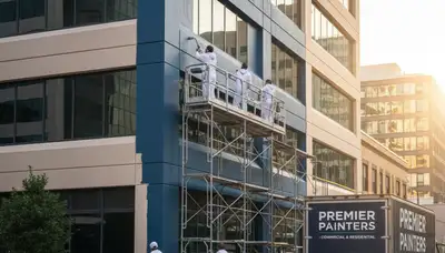 Professional commercial painters coating stucco building exterior in El Paso, TX